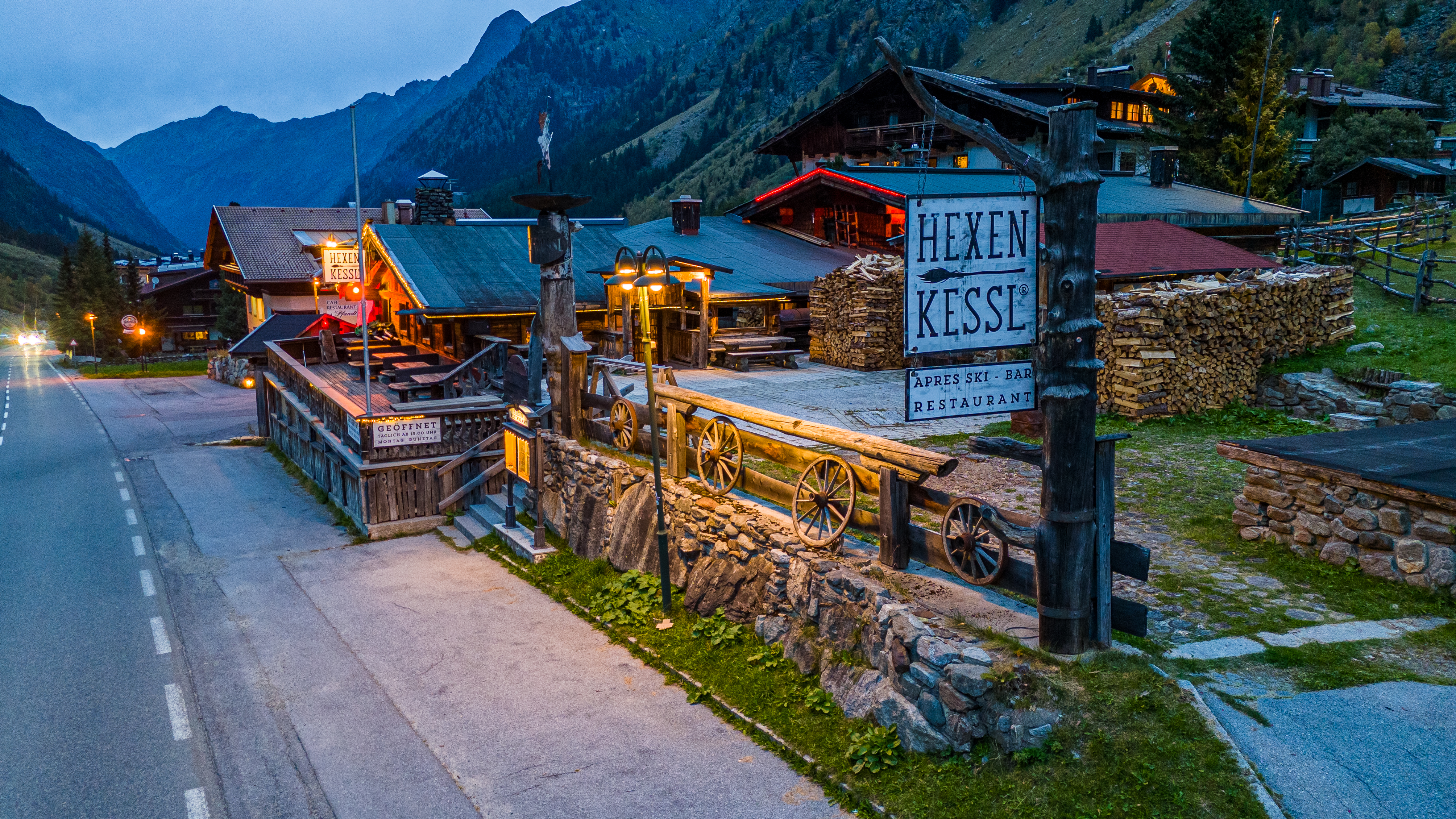 Gastronomie-Gebäude in alpiner Landschaft zur blauen Stunde